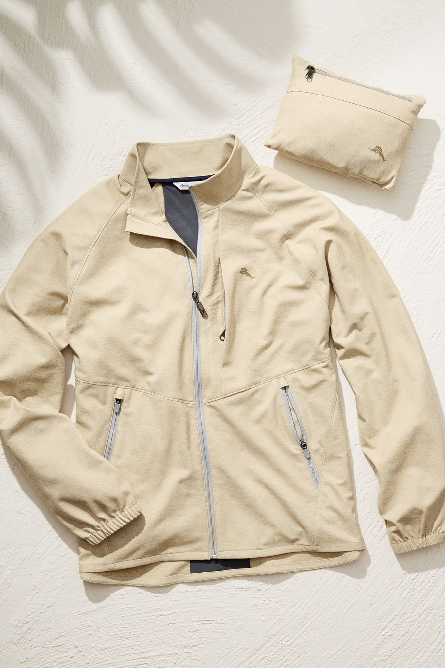 Beige jacket with a matching pouch on a light background